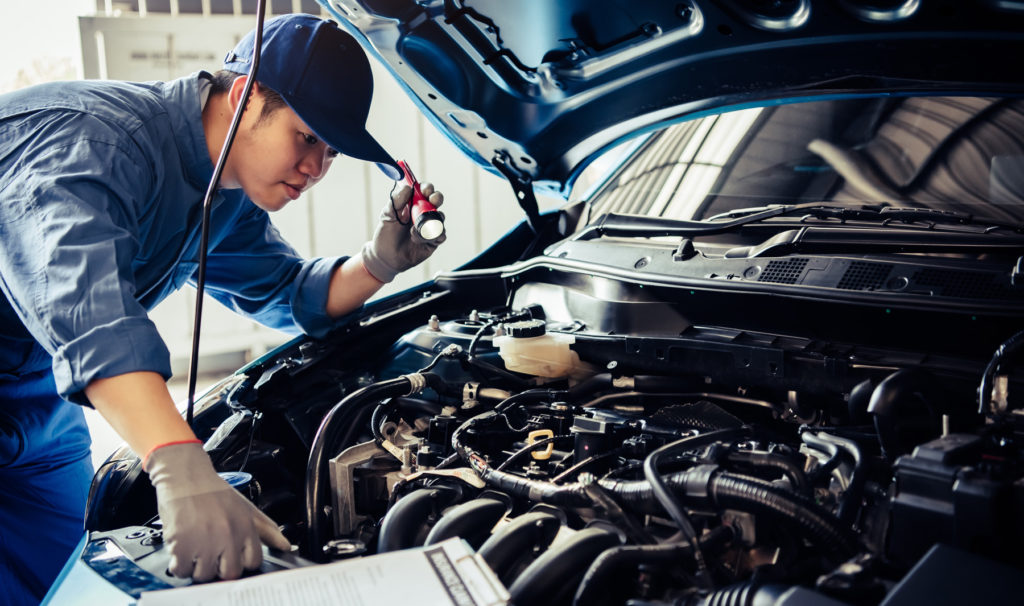 Mechanic with car repair checklist